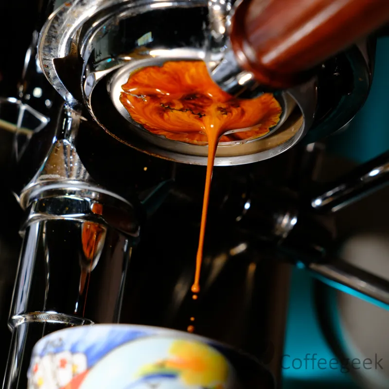 Espresso extraction in progress, coffee flowing after 20 seconds from the bottomless portafilter