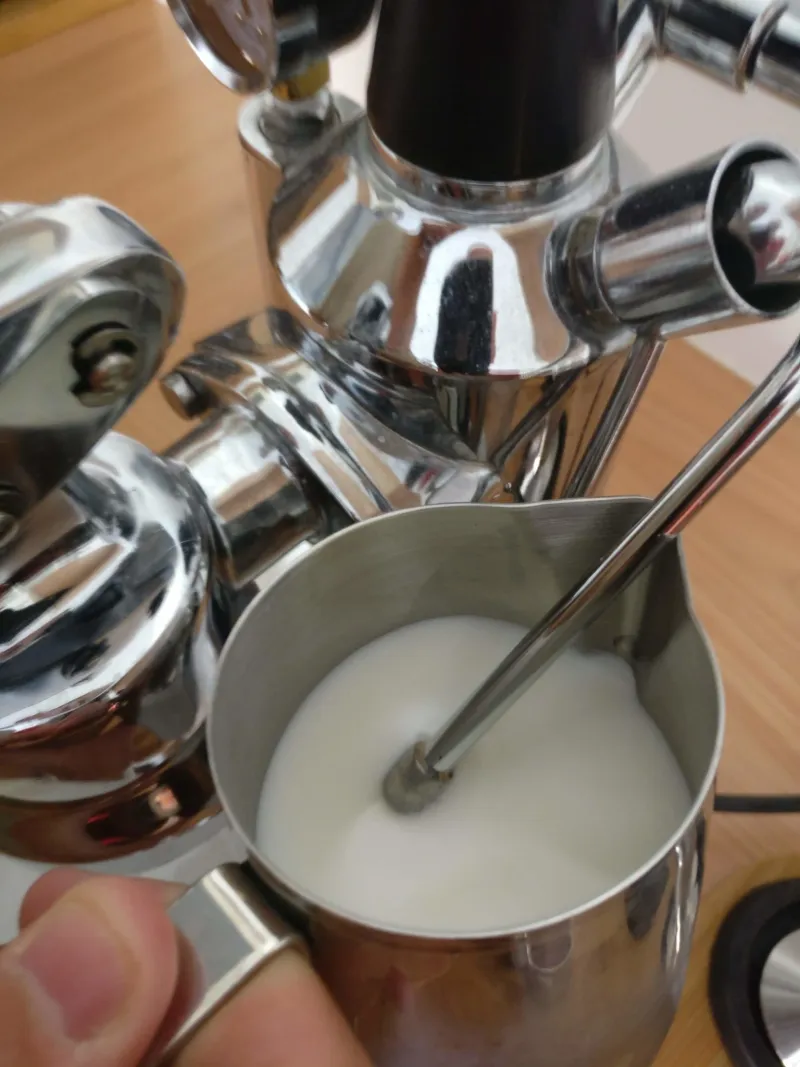 The milk is frothed using the steam wand