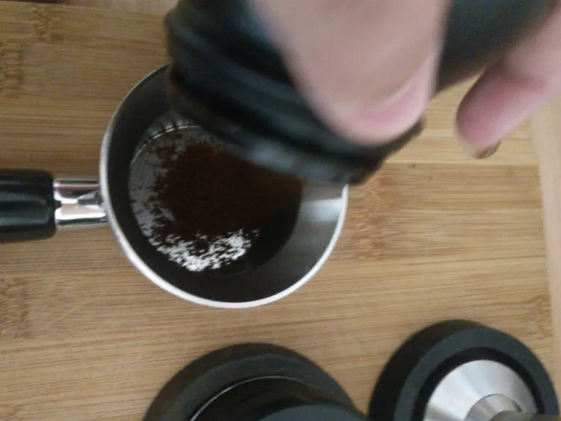 Ground coffee is poured into the filter