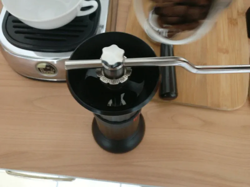 Coffee beans are poured into the Apollo coffee grinder