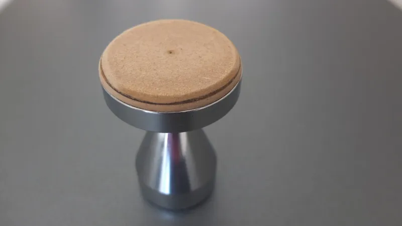 Modified tamper for rounded filter basket