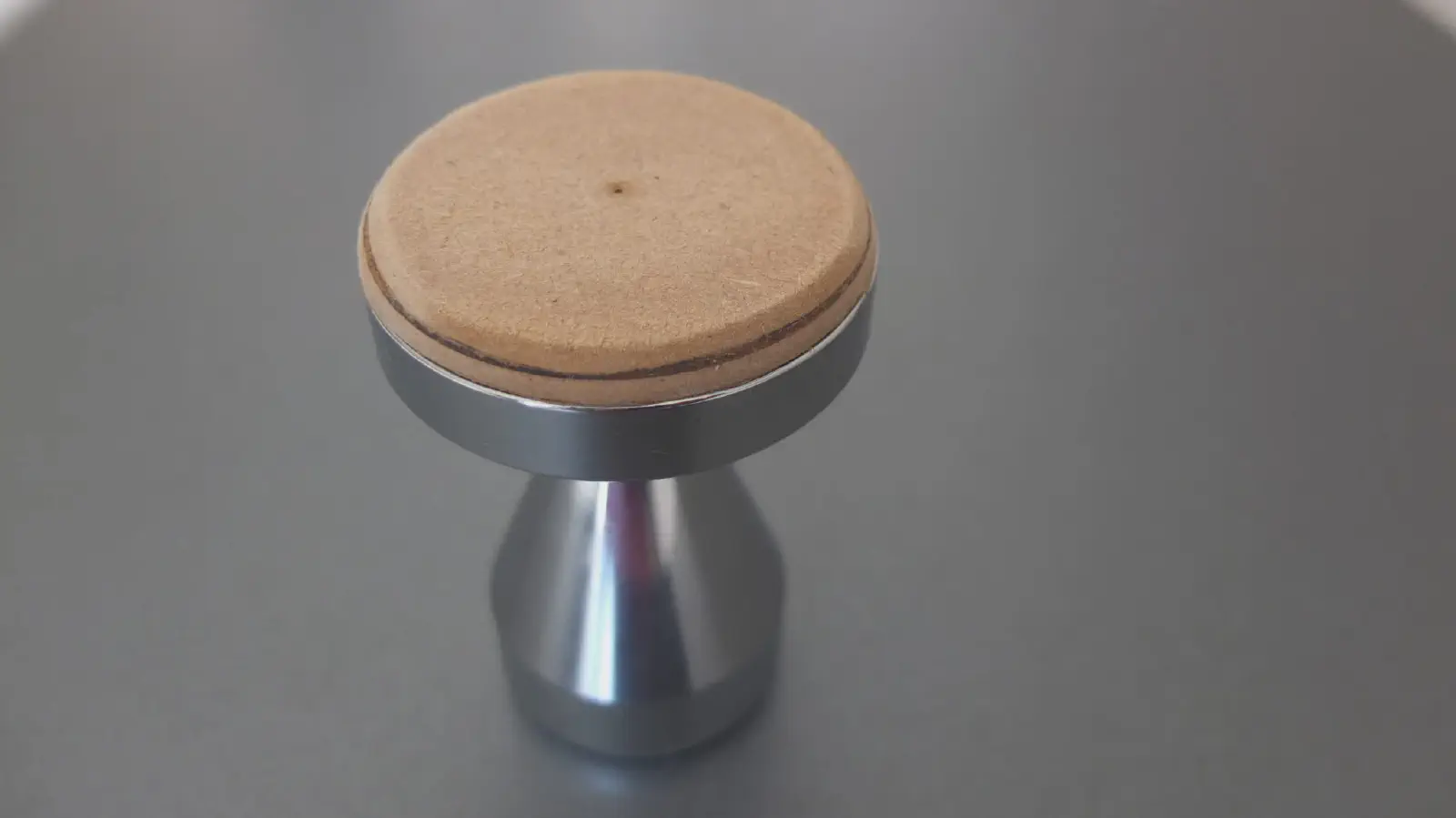 Modified tamper for rounded filter basket