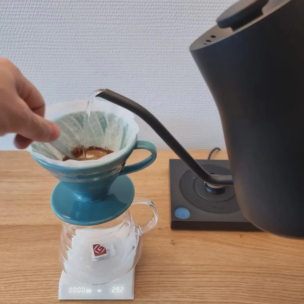 Gooseneck kettle pouring gently into a V60