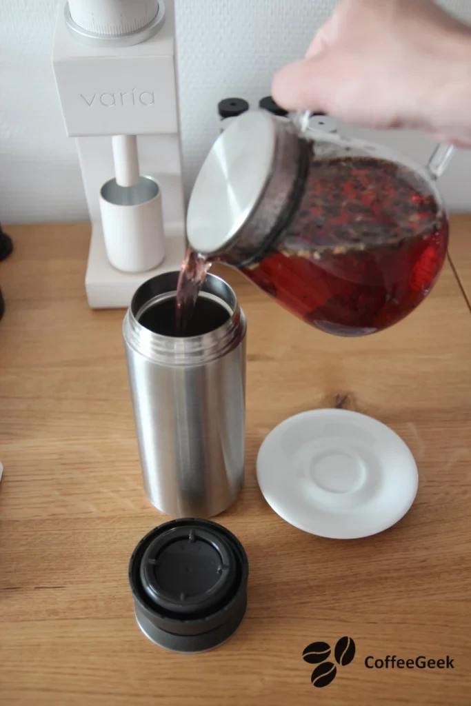 Pouring brewed tea into a bottle