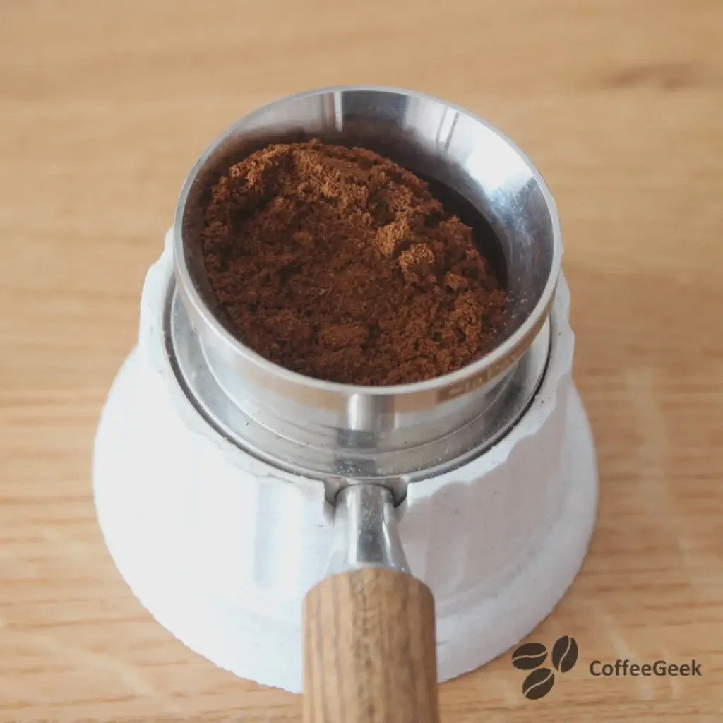 Pouring the ground coffee