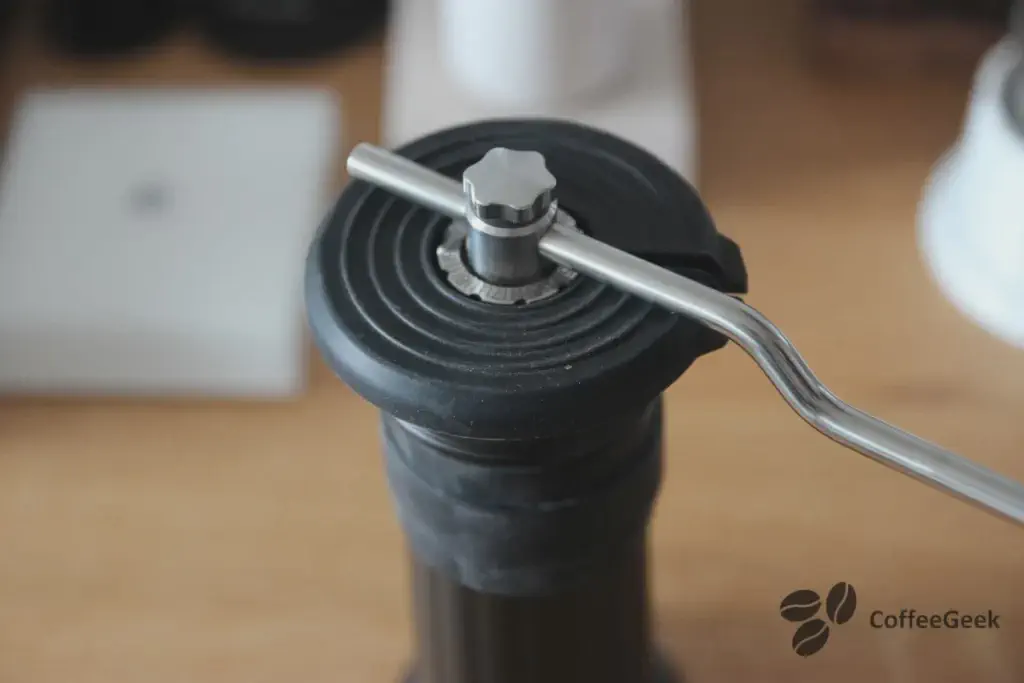 Pouring beans into the Apollo grinder's hopper