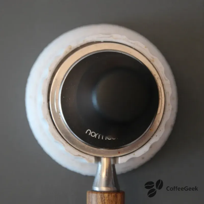 Next, I tamp the coffee with my Normcore V4 tamper